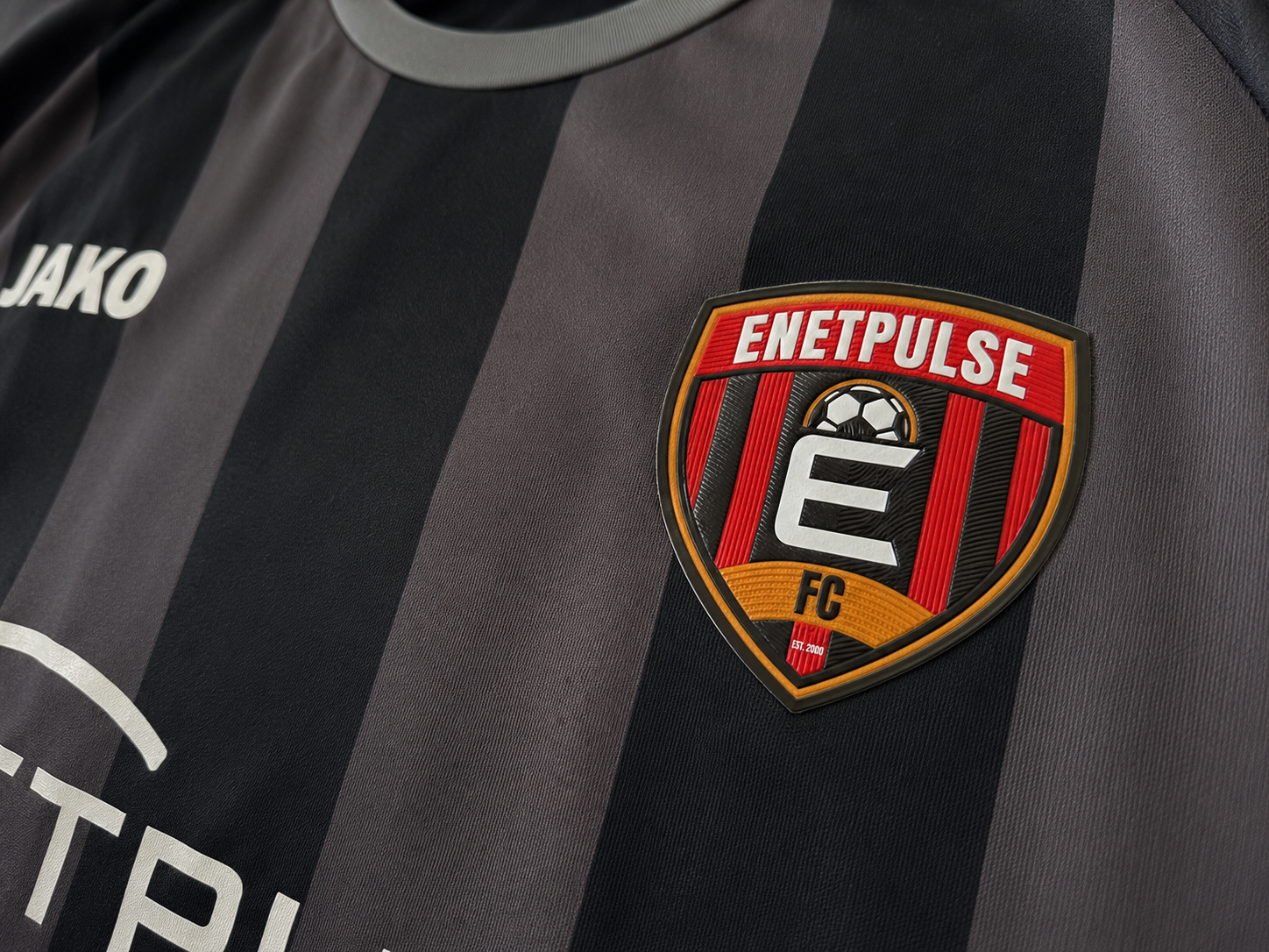 Close-up of the finished Enetpulse FC crest on the shirt